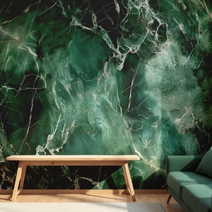 May include: A dark green marble effect wall mural with white veining. A wooden bench sits in front of the wall, and a green sofa with a matching cushion is to the right. The room has a modern, natural aesthetic.