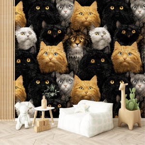 May include: A wallpaper design featuring a repeating pattern of cat faces in various colors, including black, orange, and gray. The cats have yellow eyes and are densely packed together. A white beanbag chair, a wooden giraffe planter, and a small table with blocks are in the foreground.