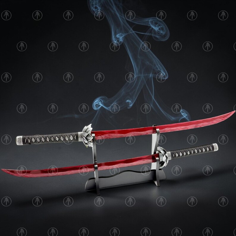 May include: Two curved swords with translucent red blades and black wrapped handles featuring silver lotus-shaped guards. The swords are displayed horizontally on a black tiered stand, with wisps of blue smoke rising behind the blades.