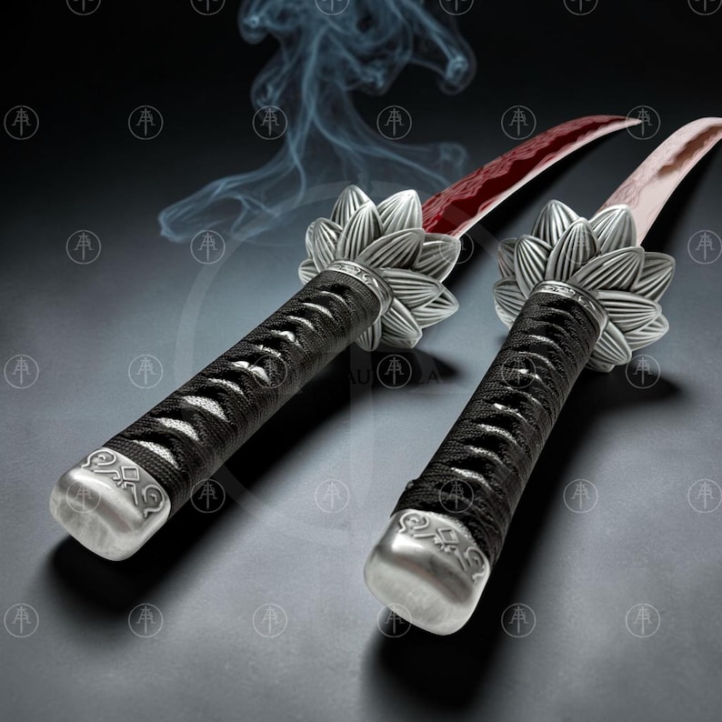 May include: Two swords with curved blades featuring a red pattern. The handles are wrapped in black cord and feature a silver-toned metal guard shaped like a lotus flower. The pommel is a silver-toned metal cap with engraved geometric patterns.