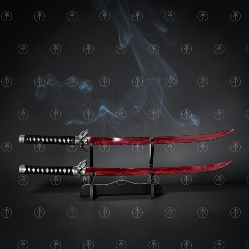 May include: Two katana swords with deep red blades and black handles featuring silver-toned accents. The swords are displayed horizontally on a black tiered stand, with wisps of smoke rising behind them against a dark, patterned background.
