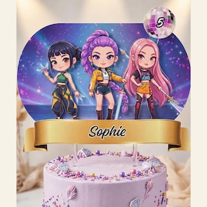 May include: A cake topper featuring three anime-style figures with weapons, set against a purple and blue background. A gold banner displays the name "Sophie". A disco ball with the number "5" is at the top. The cake is decorated with pink and purple sprinkles.
