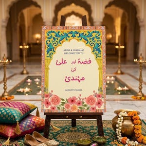 May include: A professionally designed sign for a luxury Mehndi event. The sign is on a wooden easel and features floral and ornate designs with text in English and another language. The date August 25, 2026 is also displayed.