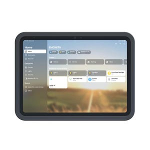 May include: A dark grey tablet showing a smart home control interface. The screen displays the "Home" screen with options for lights, climate, and security. The interface includes the text "EMONITA" and several scene options for the home.