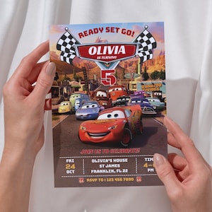 May include: A colorful birthday party invitation featuring the Cars movie characters. The invitation reads "Ready Set Go!" and "Olivia is turning 5." Details include the date, time, and location of the party. The invitation is held by a person.