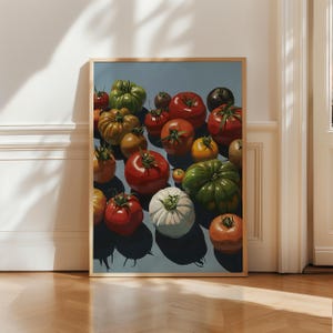 May include: A framed print featuring a still life of various tomatoes. The tomatoes are depicted in shades of red, green, yellow, and orange, with a white tomato in the center. The background is a light blue, and the frame is a natural wood color.