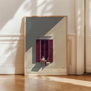 Könnte beinhalten: Ein gerahmter Wandkunstdruck, der eine Person zeigt, die auf einem Fensterbrett sitzt und auf einer Leinwand malt. Die Szene stellt eine Gebäudefassade mit dunkelroten Fensterläden, einer hellen Wand und einer Person mit einer Palette dar.