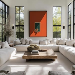 May include: A large rectangular framed wall art piece featuring a vibrant orange background with a central green shuttered window where a figure sits playing an acoustic guitar, displayed above a cream-colored sectional sofa and wooden coffee table.