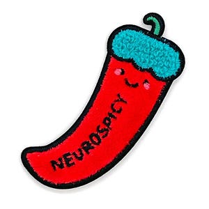May include: A red embroidered patch in the shape of a chili pepper with a smiling face and the word "NEUROSPICY" in black text. The top of the pepper is teal and fluffy, with a green stem. The patch has a black border.