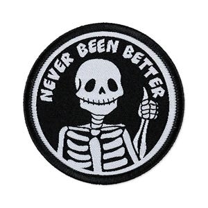 May include: A white ceramic mug with a black handle and the text "But First, Coffee" in a bold, black font. The mug is set against a blurred background, suggesting a cozy setting.