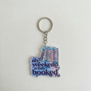 May include: A white ceramic mug with a black handle and the text "But First, Coffee" in a handwritten style. The mug is on a white surface. The mug is approximately 4 inches tall.