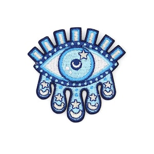 May include: Embroidered patch featuring a blue eye design with white accents. The eye has a blue iris with a crescent moon and star, surrounded by a blue border. The patch has a teardrop design with stars and crescent moons.