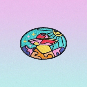 May include: Embroidered patch featuring a colorful UFO design. The patch has a black border and depicts a red and pink flying saucer above a yellow mountain, with a smiling sun and stars in a teal sky. The background is a gradient of pink and blue.