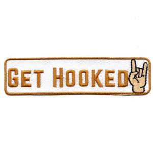 May include: Embroidered patch with the words "GET HOOKED" in gold lettering on a white background. A hand gesture with the index and pinky fingers raised is on the right side. The patch has a gold border.