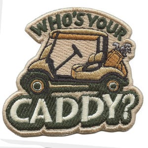 May include: Embroidered patch featuring a golf cart with the text "WHO'S YOUR CADDY?" in a green and tan color scheme. The patch has a detailed design of a golf cart with golf clubs in a bag. Perfect for golf enthusiasts.