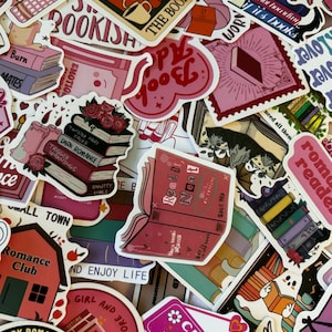 May include: A selection of vibrant stickers with a bookish theme. The stickers showcase diverse designs, such as book stacks, hearts, and phrases like "Read It Next" and "Romance Club". The colour scheme incorporates pinks, reds, and whites.