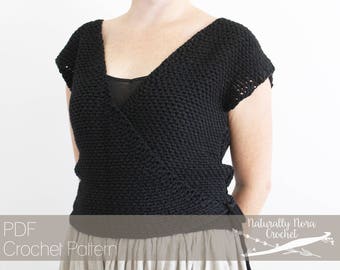 May include: A black crochet wrap top with a V-neck and short sleeves. The wrap top is tied at the side. The model is wearing a light-colored skirt. The text "PDF Crochet Pattern" and "Naturally Nora Crochet" is visible in the image.