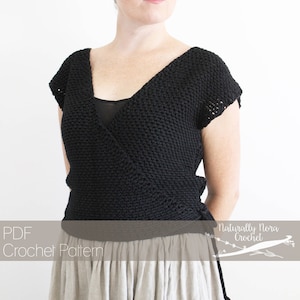 May include: A black crochet wrap top with a V-neck and short sleeves. The wrap top is tied at the side. The model is wearing a light-colored skirt. The text "PDF Crochet Pattern" and "Naturally Nora Crochet" is visible in the image.