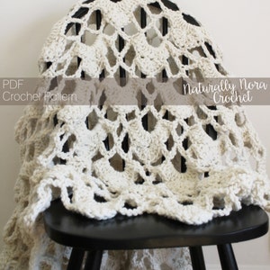 May include: A white crochet blanket with a delicate lace pattern draped over a black wooden chair. The text "PDF Crochet Pattern" and "Naturally Nora Crochet" is visible on the image.