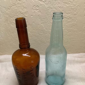 Antique Amber John Wyeth Bottle and Blue Tint Jacob Ruppert -New York Brewer Bottles.