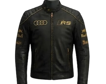 May include: Black leather jacket with gold accents, featuring the Audi logo and "RS" lettering. The jacket has a zip-up front, quilted shoulders, and Red Bull branding on the sleeves. A stylish, vintage-inspired motorcycle jacket.