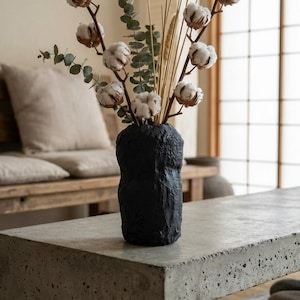 May include: A handmade wooden sign with the text "Welcome to our home" in a handwritten style. The sign is painted white with a distressed finish and a dark brown border. A small, decorative heart is attached to the bottom.