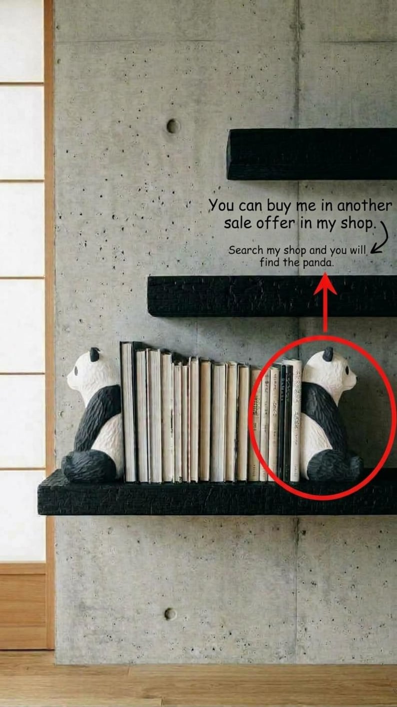 May include: Two black and white panda-shaped bookends positioned on a black shelf, holding a row of books between them. The panda figures are depicted in a seated posture, facing inward toward the books, with detailed black and white coloring.