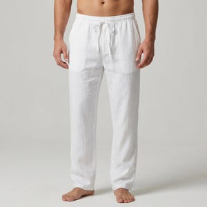 May include: White linen pants with a drawstring waist. The pants have a relaxed fit and a straight leg. The fabric appears lightweight and breathable, suitable for warm weather. The pants are a solid white color.