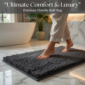 May include: A rectangular grey chenille bath rug with a textured surface and a dark grey border. The image includes the text "Ultimate Comfort & Luxury" and "Premium Chenille Bath Rug".