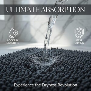May include: A dark grey bath mat with a textured surface, absorbing water from a stream. The image includes text that reads "ULTIMATE ABSORPTION" and "Experience the Dryness Revolution."