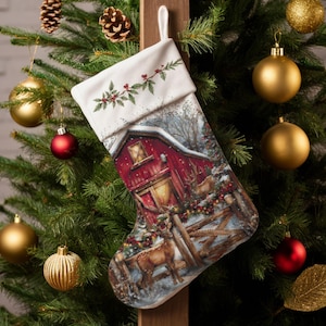 May include: A Christmas stocking with a festive barn scene, featuring a red barn, deer, and snow. The top of the stocking is white with a holly and berry design. The stocking is hanging on a wooden post, surrounded by a Christmas tree with ornaments.