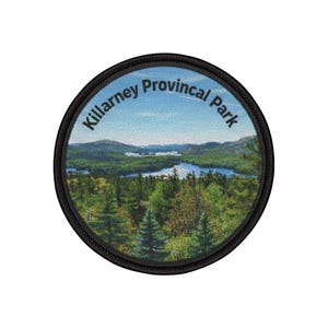 May include: Circular patch depicting Killarney Provincial Park. The design shows a lake surrounded by green trees and mountains under a blue sky. The text "Killarney Provincial Park" is arched around the top edge of the patch.