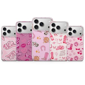 May include: Five smartphone cases arranged in a row, each featuring a unique pink-themed pattern. Designs include cow print cowboy hats, disco balls, boots, hearts, lips, butterflies, cherries, and the text YEE HAW printed on a light pink background.