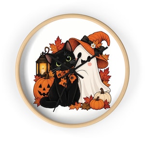 May include: A round wall clock with a light wood frame featuring a black cat wearing an orange pumpkin-patterned bow tie, a white ghost in an orange witch hat, a lit lantern, pumpkins, and autumn leaves on a white background with black hands.