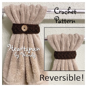 May include: Crochet pattern for a reversible towel ring. The ring is brown and has a button in the center. The towel is beige and is hanging on a towel rack. The text "Heartspun by Wendy" is written on the towel. The text "Crochet Pattern" is written in the top right corner of the image. The text "Reversible!" is written in the bottom right corner of the image.