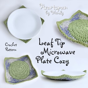 May include: Crochet pattern for a green and purple leaf tip microwave plate cosy. The cosy is shown with a white plate inside.
