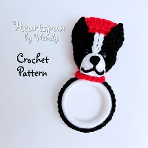 May include: Crochet pattern for a black and white Boston Terrier dog wearing a red hat and scarf. The pattern is called "Heartspun by Wendy".