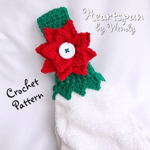May include: A crochet pattern for a red poinsettia flower with green leaves. The pattern is called "Heartspun by Wendy" and is for a kitchen towel.