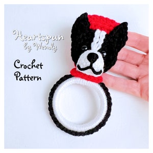 May include: Crochet pattern for a black and white Boston Terrier dog with a red hat and scarf. The pattern is called "Heartspun by Wendy".