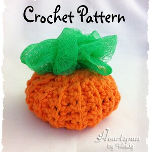 May include: Crochet pattern for a pumpkin-shaped scrubbie with a green mesh top. The pattern is called "Heartspun by Wendy".