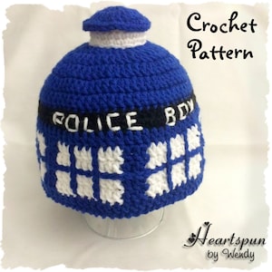 May include: Crochet pattern for a blue and white hat shaped like a Dalek, a fictional robot from the British science fiction television series Doctor Who. The hat features the text "POLICE BOX" on the front.