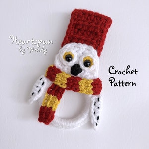 May include: Crochet pattern for a white owl wearing a red and gold scarf and a red hat. The pattern is called "Heartspun by Wendy".