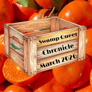 May include: A wooden crate with the text "Swamp Queer Chronicle March 2026" and "Digital Edition" sits atop a pile of bright orange tangerines. The crate has a green illustration on the side.