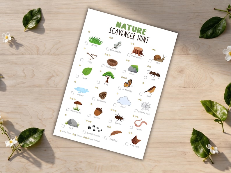 May include: A white paper with a "Nature Scavenger Hunt" checklist, featuring illustrations of natural elements like grass, leaves, and insects. The checklist includes check boxes and stars for marking finds. The paper is on a light wood surface.
