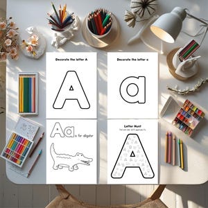 May include: Four white activity sheets with the letter "A" are displayed, along with colored pencils and crayons. The sheets include the text "Decorate the letter A", "A is for alligator", and "Letter Hunt". The image is taken from an overhead perspective.