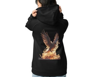 Unisex Öko-Raglan-KapuzenpulloverMajestätischer Adler, der aus dem Feuer aufsteigt, ein starkes Symbol für Freiheit und Mut. Ideal für mutige T-Shirts und Wandkunst