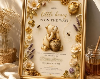 May include: A framed baby shower invitation featuring a gold-toned illustration of a bear with a honey pot, surrounded by floral and honeycomb accents. The text reads: Our little honey IS ON THE WAY! JOIN US TO CELEBRATE A BABY SHOWER FOR A MOM-TO-BE Olivia James 10.25.2026 AT 9 PM OLIVIA S RESIDENCE 786 ANYWHERE ST., ANY CITY, ST 98760 RSVP TO MOM AT 564-456-0987.