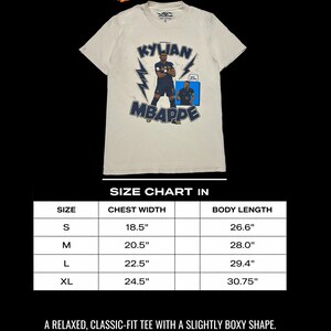 May include: Cream-coloured t-shirt with a Kylian Mbapp&eacute; graphic, lightning bolts, and text. Includes a size chart with chest width and body length measurements in inches. The shirt is a relaxed, classic-fit tee.