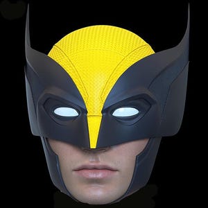 May include: A black and yellow Wolverine mask with white eye lenses. The mask features a textured yellow top and black detailing, including pointed ear-like extensions. The mask is designed to fit over a person's face.