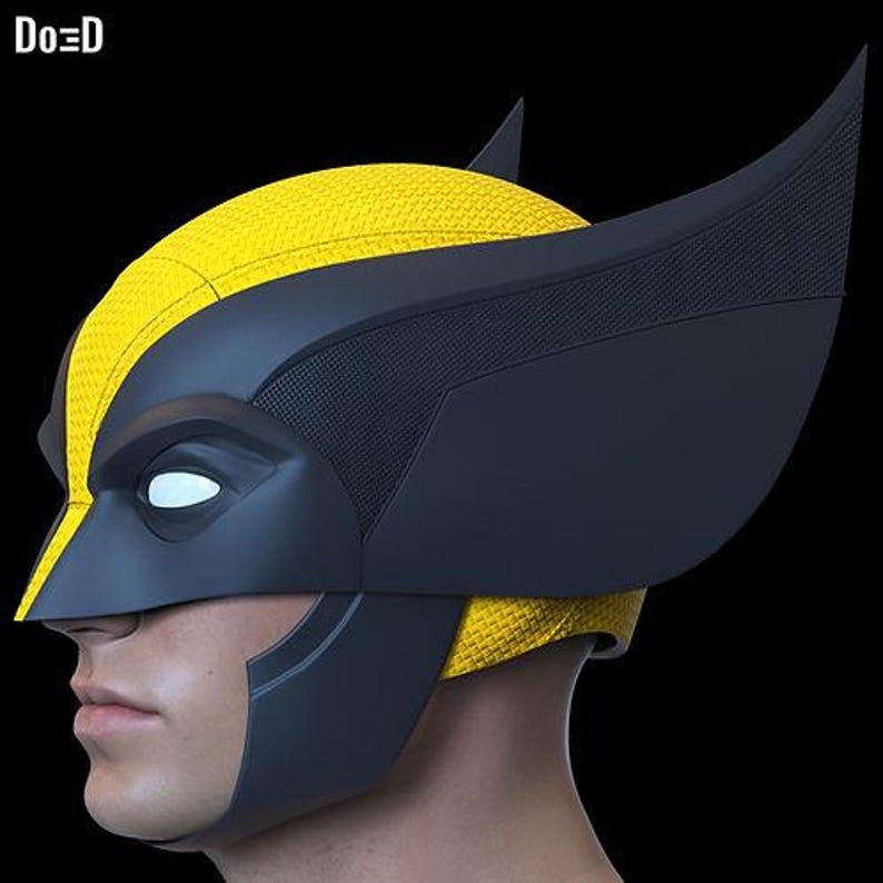 May include: A yellow and black Wolverine mask, with a textured yellow top and sleek black accents. The mask features pointed ear-like extensions and a distinctive eye shape, set against a black background.